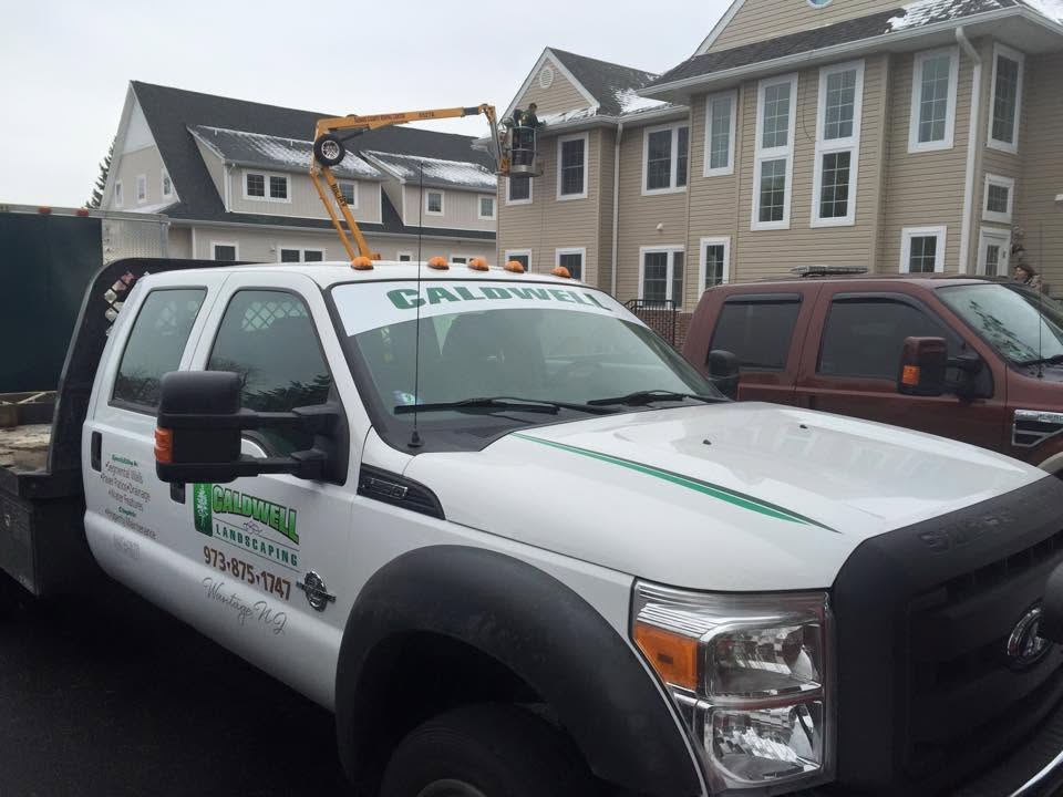 Caldwell Landscaping truck and lift at a Sussex County jobsite